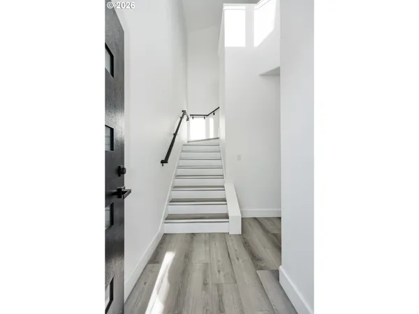 a view of a room with wooden floor