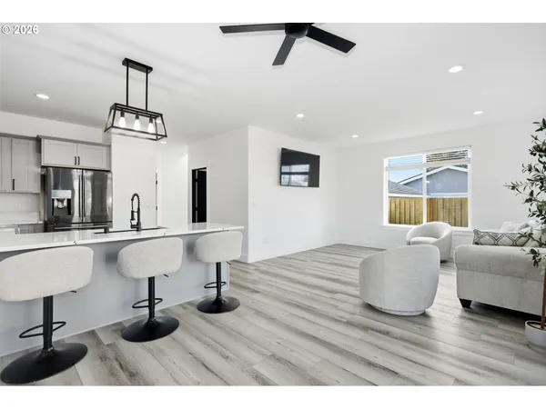 a living room with kitchen island furniture and a wooden floor