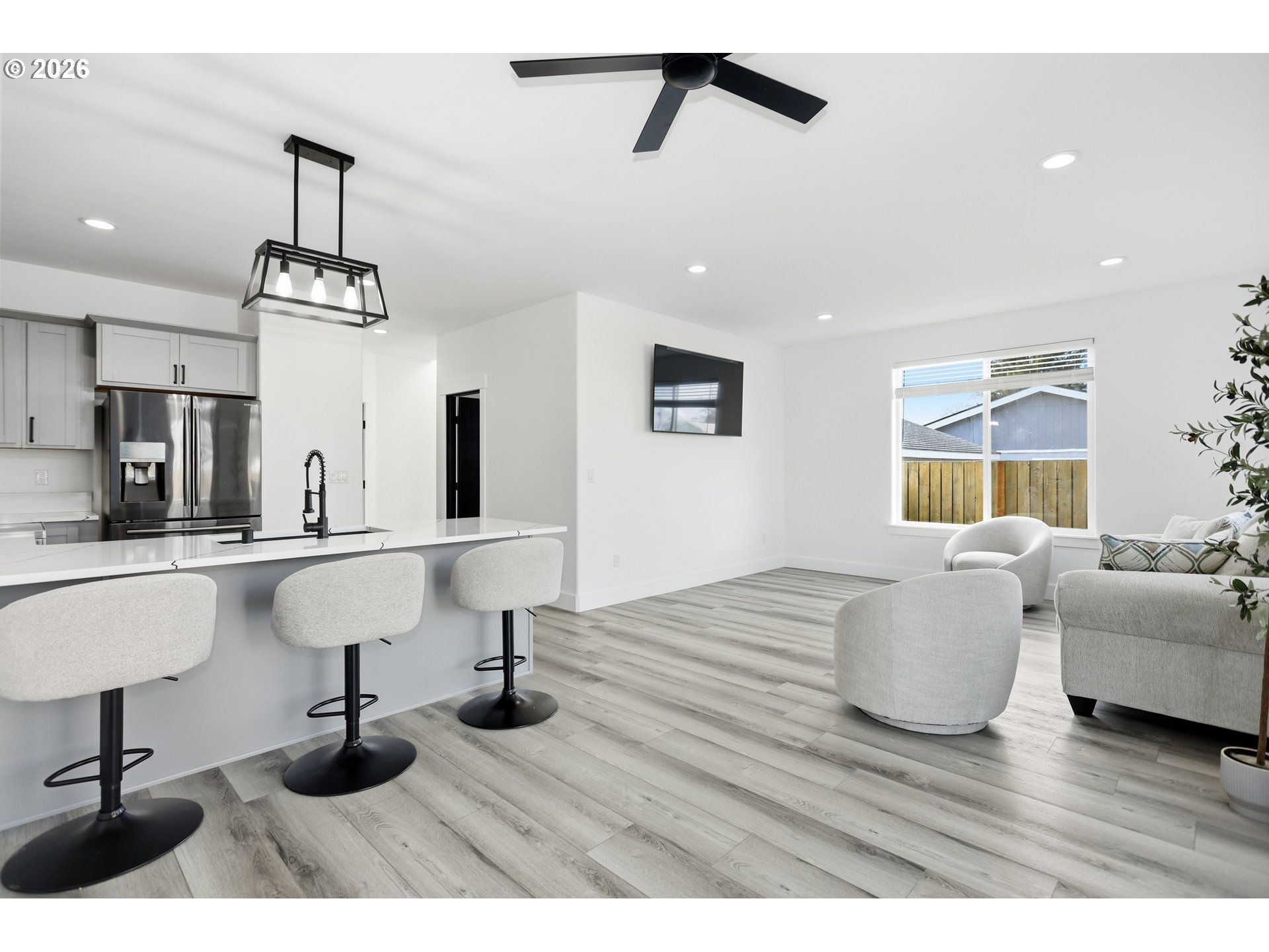 511 East Collins Street Goldendale, WA 98620 - Photo 7 of 41 a living room with kitchen island furniture and a wooden floor