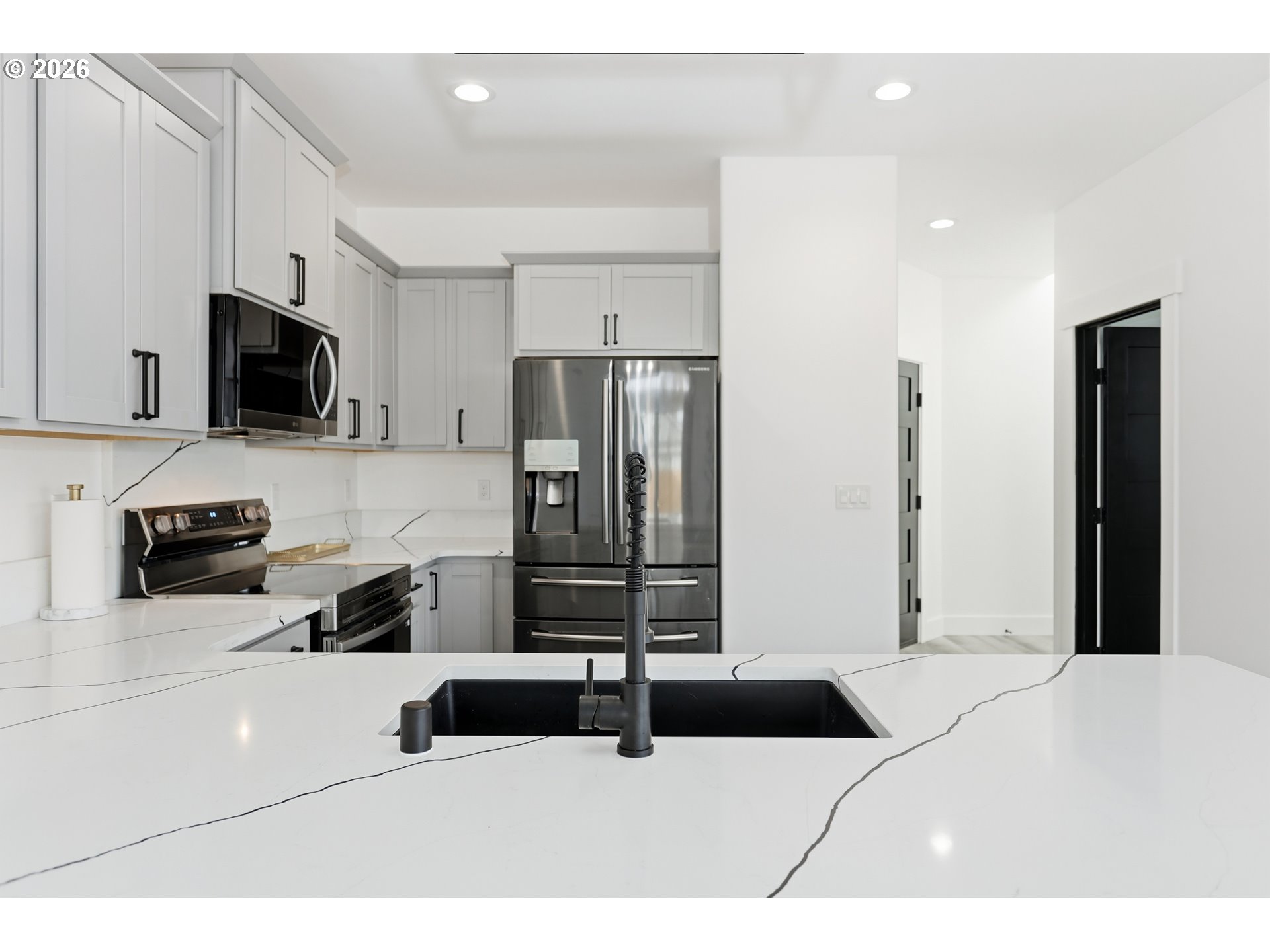 511 East Collins Street Goldendale, WA 98620 - Photo 8 of 41 a bedroom with a bed a television and a refrigerator