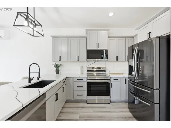 a kitchen with a sink stainless steel appliances and cabinets