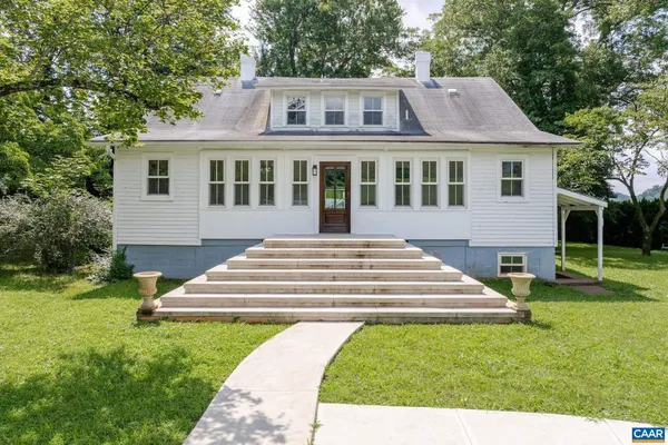 a kitchen with stainless steel appliances white cabinets and wooden floors