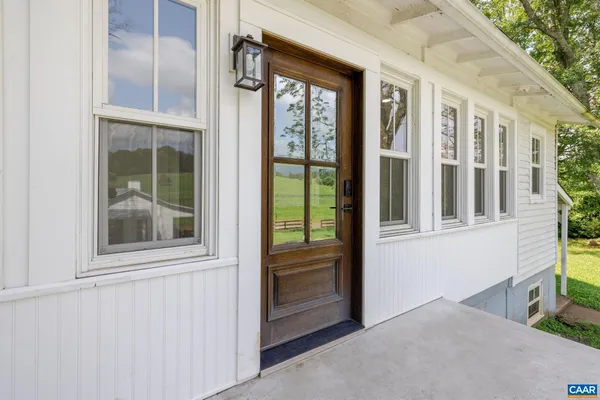 a kitchen with stainless steel appliances kitchen island granite countertop a stove a sink a refrigerator and cabinets