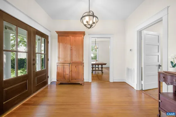 a kitchen with stainless steel appliances granite countertop a stove a sink dishwasher a stove a dining table and chairs with wooden floor