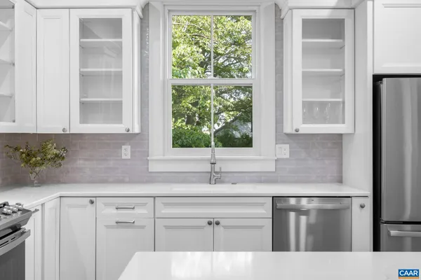 a view of a kitchen with furniture and wooden floor