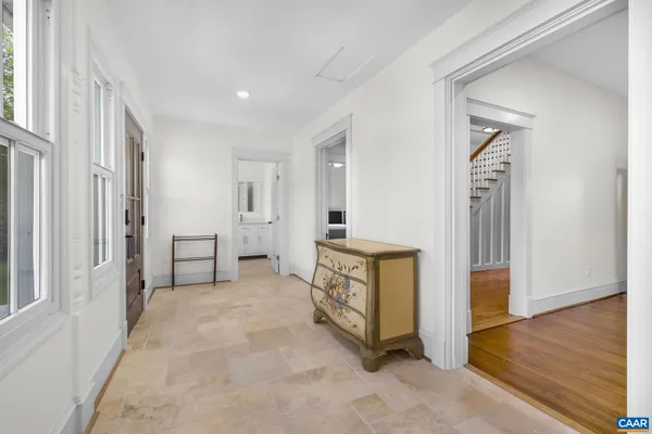 a view of a house with a big yard potted plants and a large tree
