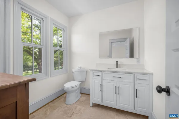a front view of a house with swimming pool and porch with furniture