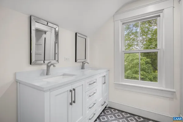 a bedroom with a bed and a view of room