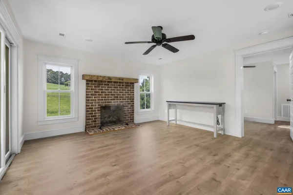 an aerial view of a residential houses with outdoor space and trees