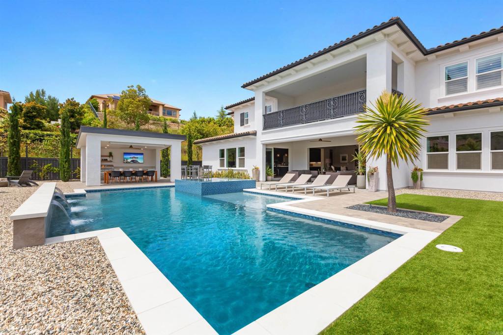 a view of a house with swimming pool and sitting area