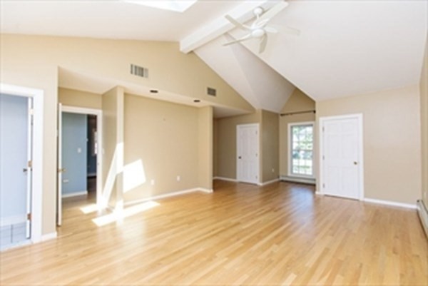 82 Beechwood Road Wellesley, MA 02482 - Photo 21 of 25 a view of a big room with wooden floor and windows