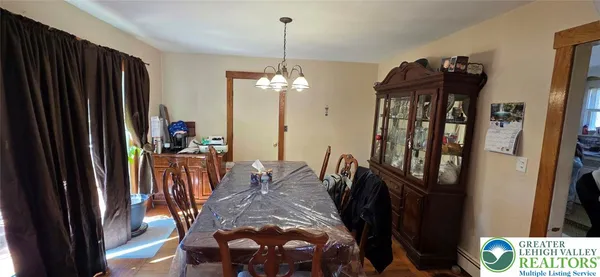 a view of a dining room with furniture and chandelier