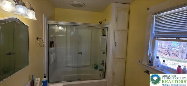 a bathroom with a sink mirror and toilet