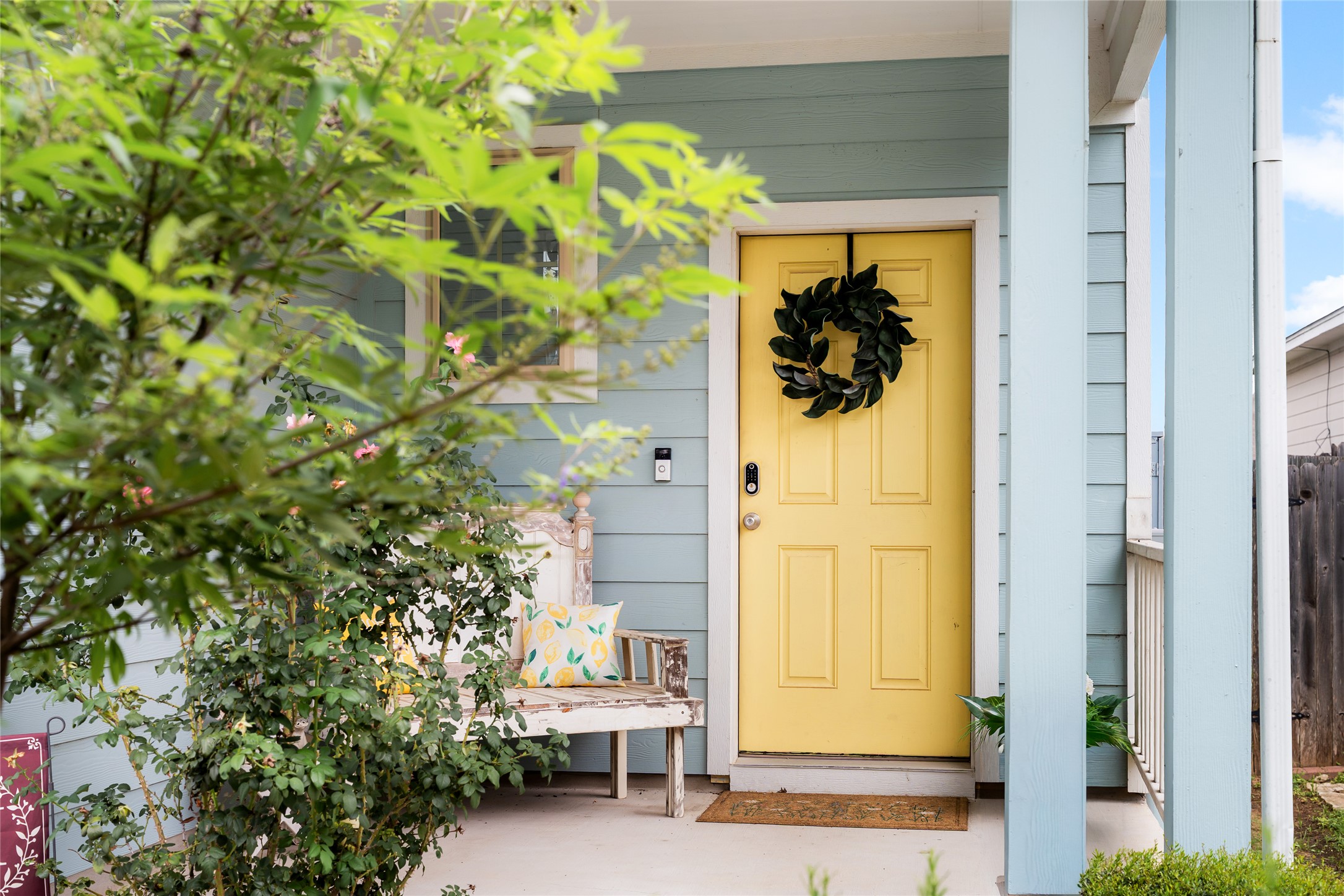 249 Wapiti Road Buda, TX 78610 - Photo 2 of 21 A cheerful yellow front door welcomes visitors to this charming residence with inviting curb appeal.