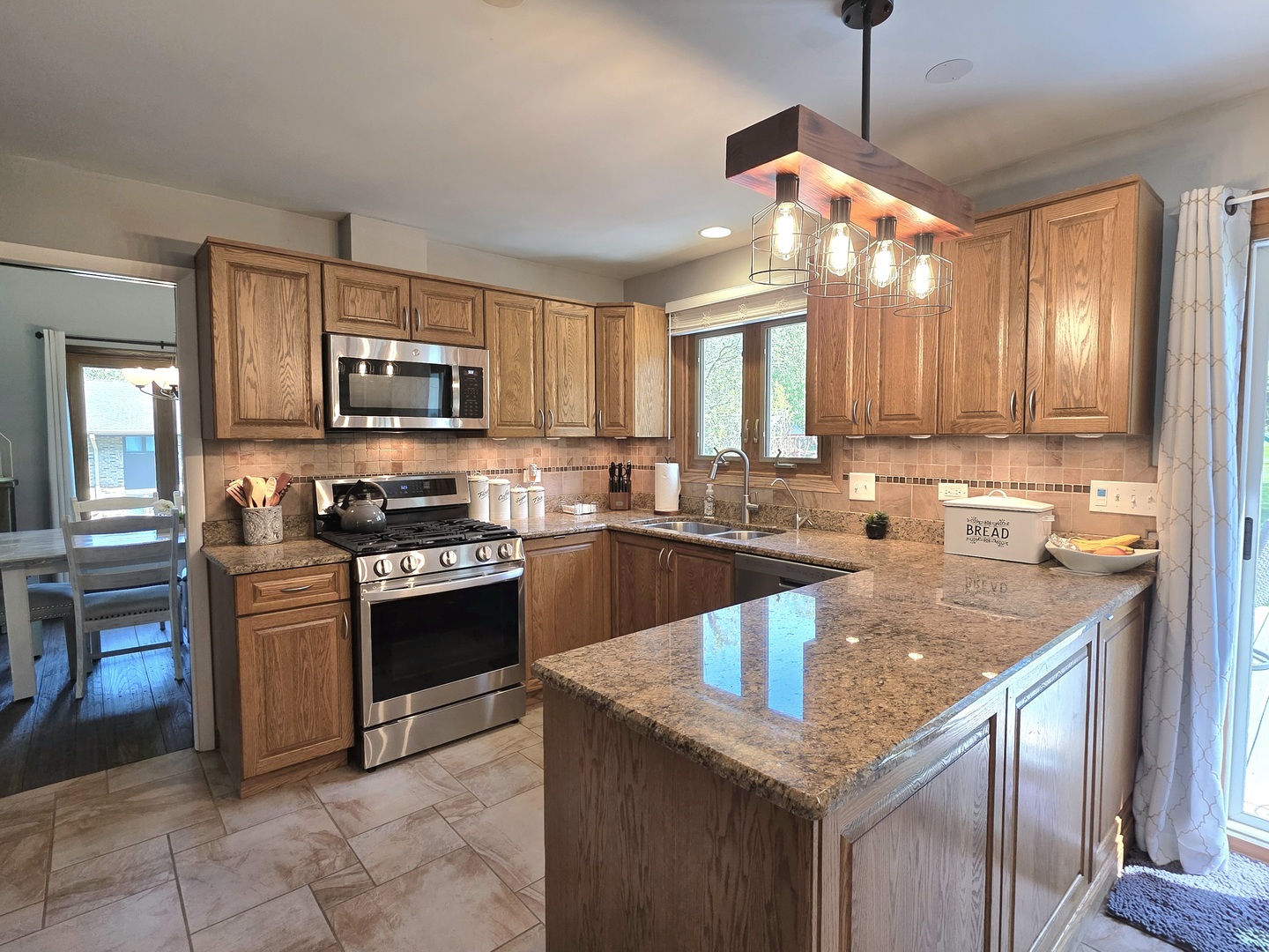 574 Aberdeen Road Frankfort, IL 60423 - Photo 5 of 37 a kitchen with stainless steel appliances granite countertop a sink stove and refrigerator