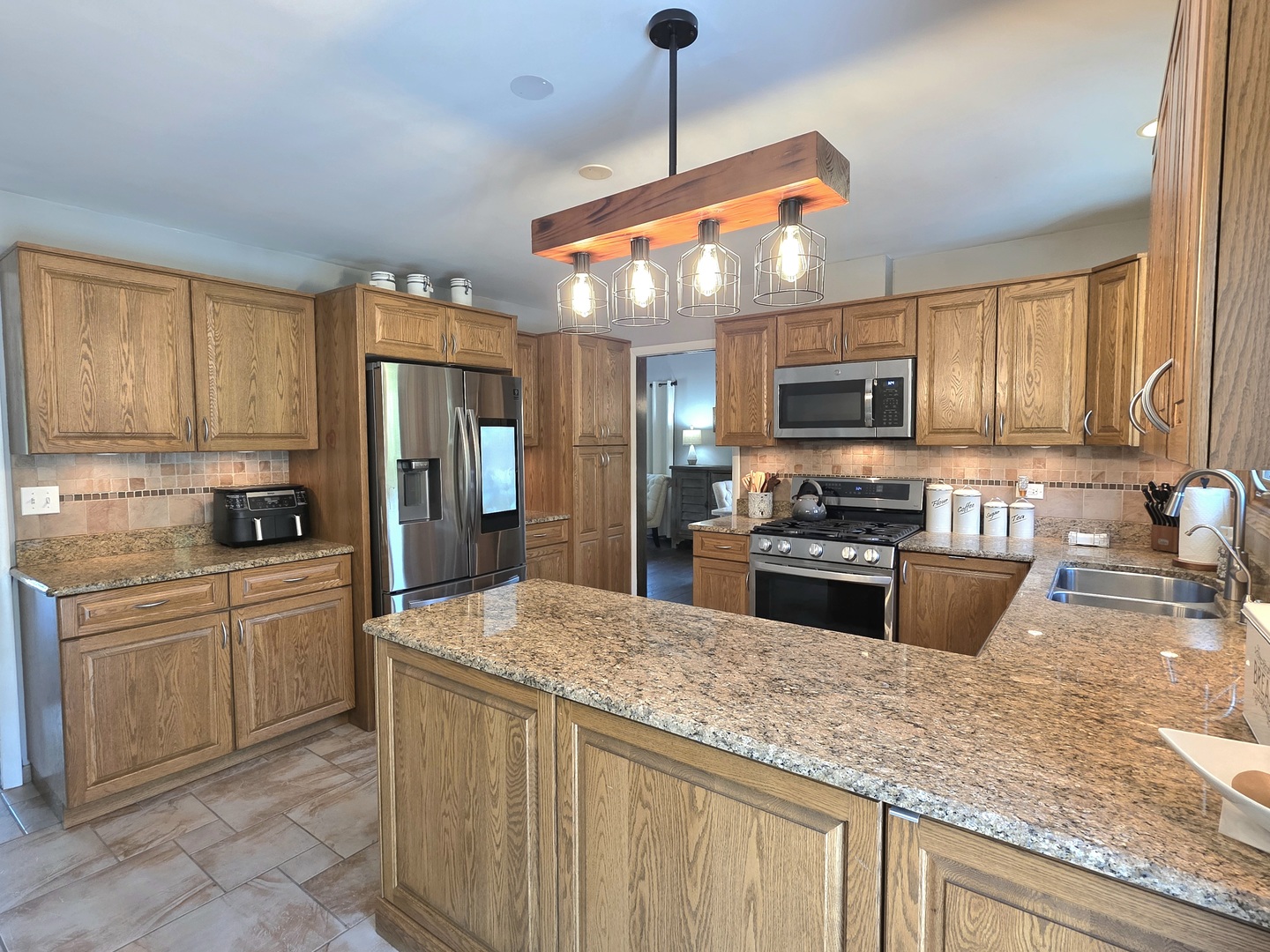 574 Aberdeen Road Frankfort, IL 60423 - Photo 6 of 37 a kitchen with stainless steel appliances granite countertop a stove refrigerator sink and microwave