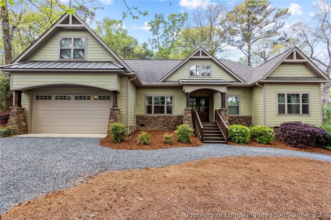 208 Rob Roy Road Southern Pines, NC 28387 - Photo 2 of 48 a front view of a house with garden