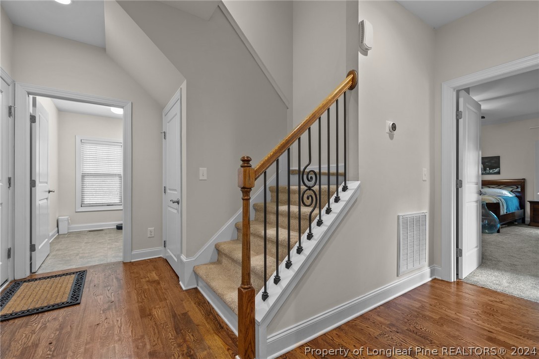 208 Rob Roy Road Southern Pines, NC 28387 - Photo 24 of 48 a view of a hallway with wooden floor and staircase