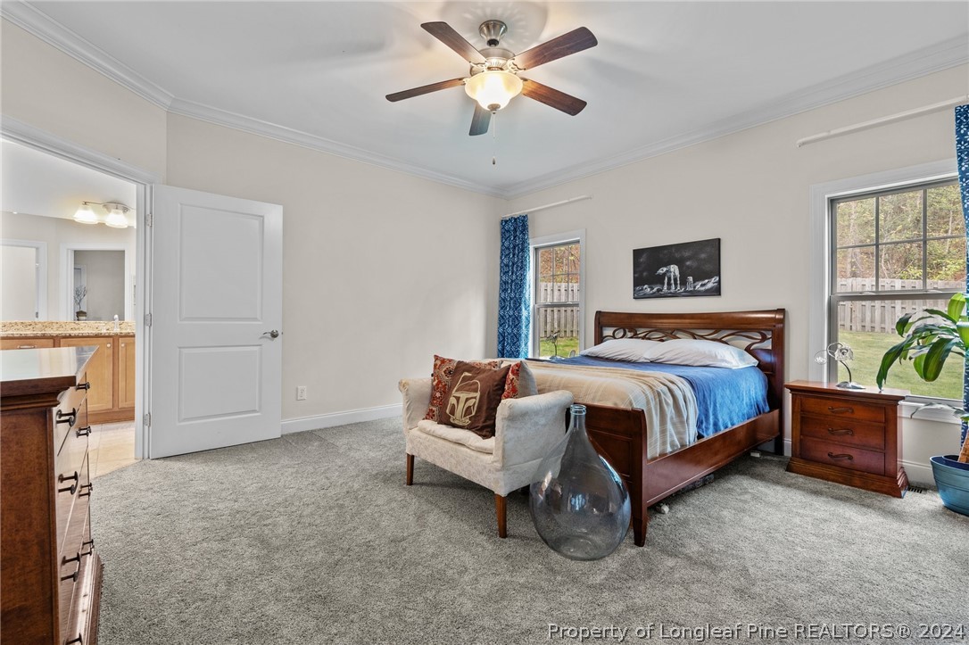 208 Rob Roy Road Southern Pines, NC 28387 - Photo 26 of 48 a bedroom with a bed and a chandelier