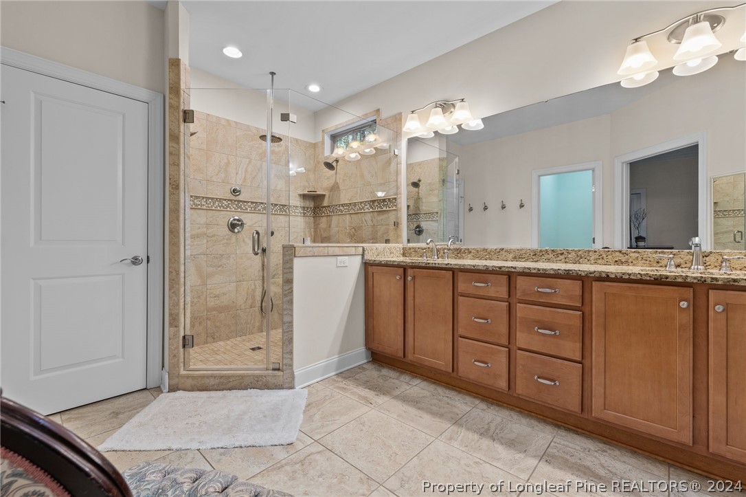 208 Rob Roy Road Southern Pines, NC 28387 - Photo 29 of 48 a spacious bathroom with a granite countertop sink mirror and shower