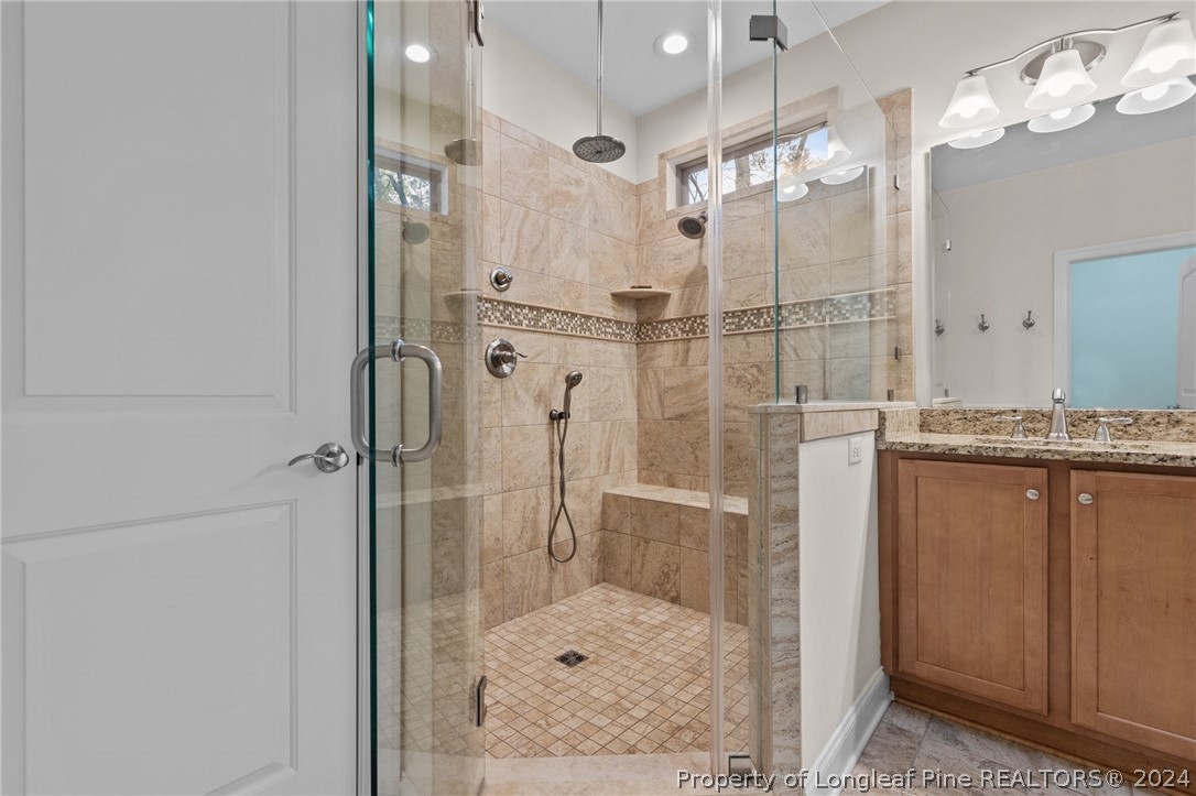 208 Rob Roy Road Southern Pines, NC 28387 - Photo 30 of 48 a bathroom with a shower sink and mirror
