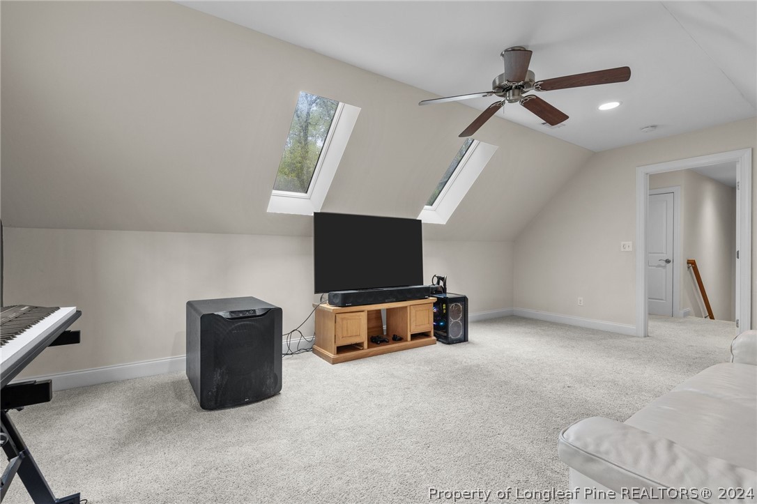 208 Rob Roy Road Southern Pines, NC 28387 - Photo 35 of 48 a living room with furniture and a flat screen tv
