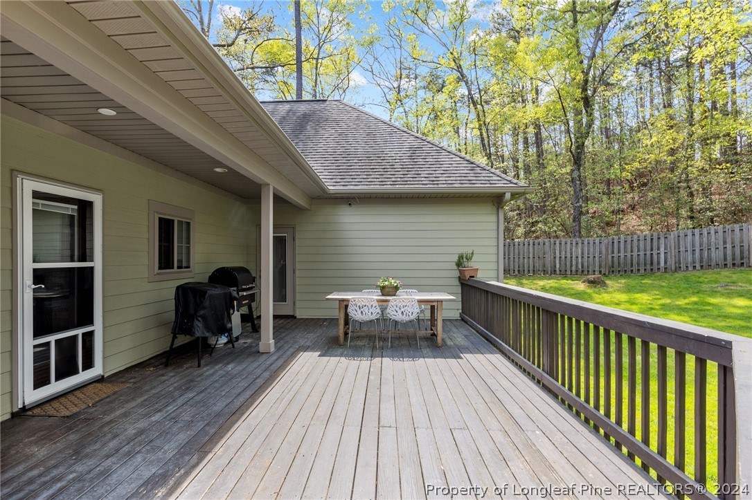 208 Rob Roy Road Southern Pines, NC 28387 - Photo 45 of 48 a view of house with deck outdoor seating and wooden floor