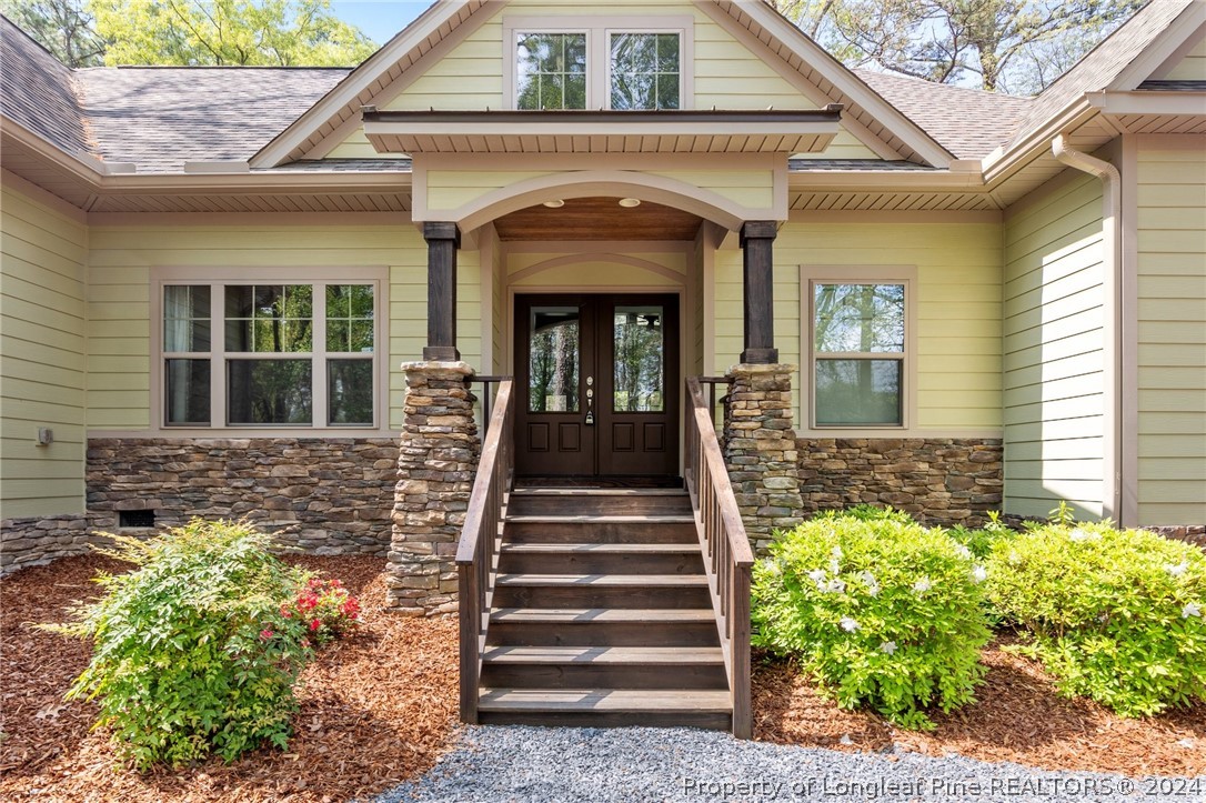 208 Rob Roy Road Southern Pines, NC 28387 - Photo 6 of 48 a front view of a house with a garden