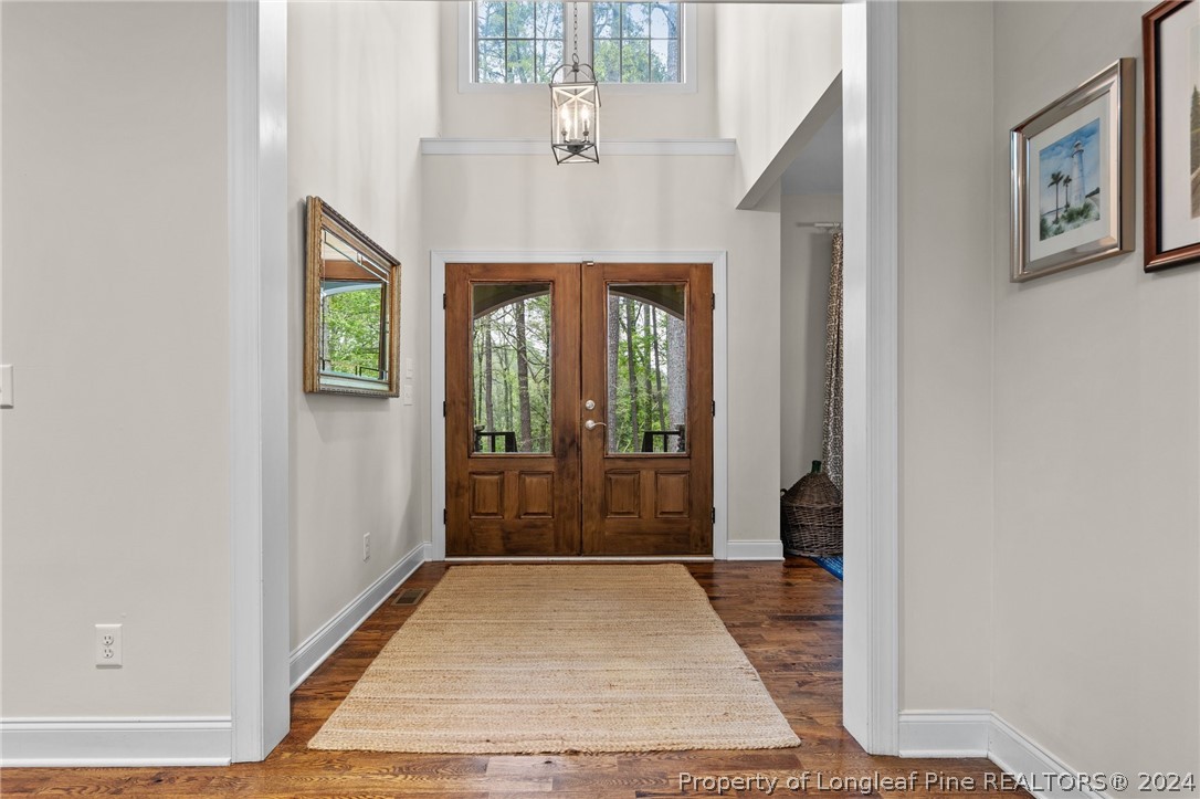 208 Rob Roy Road Southern Pines, NC 28387 - Photo 8 of 48 a view of a hallway with windows and chandelier