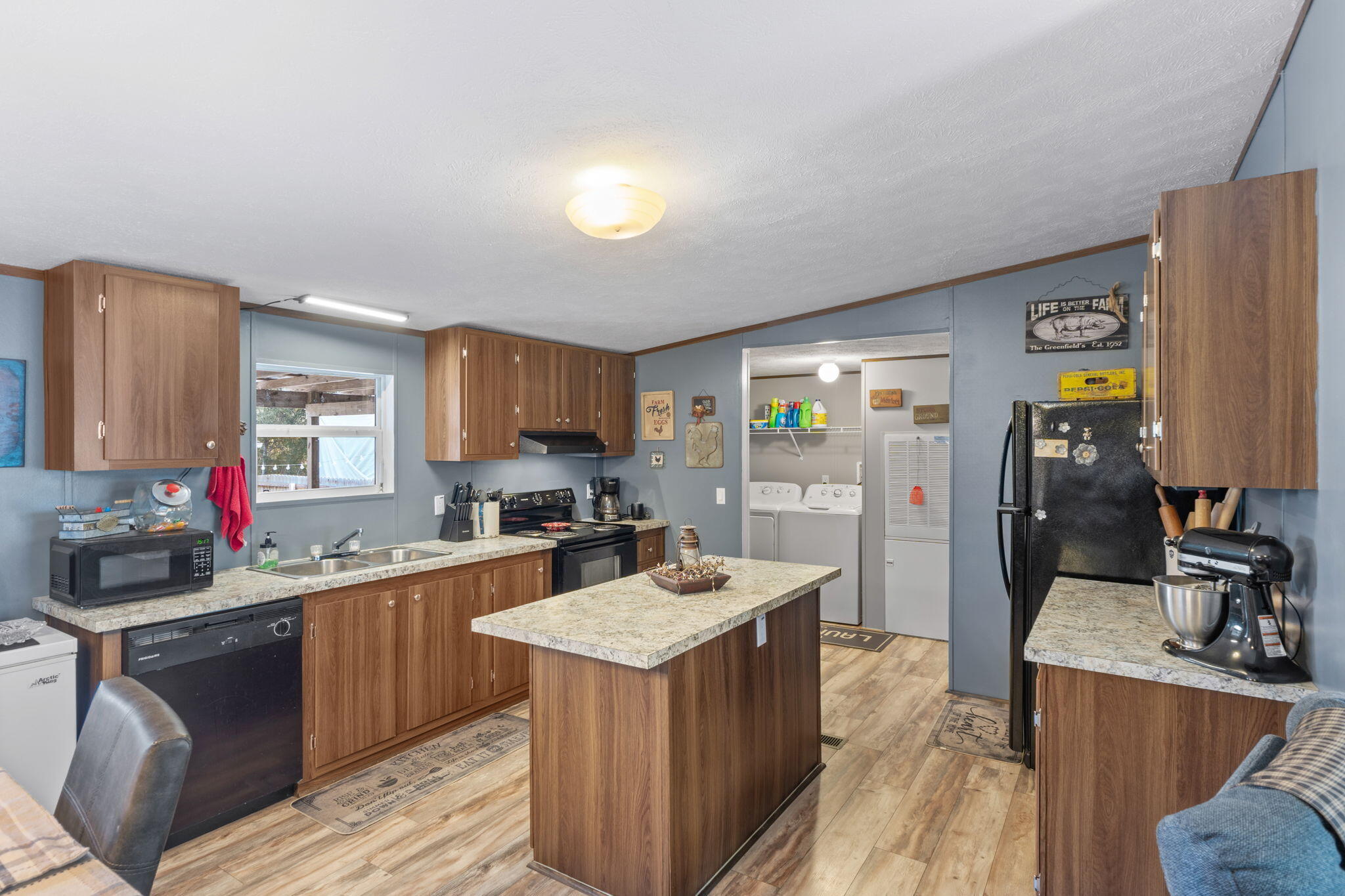 8680 John Hamm Road Milton, FL 32583 - Photo 12 of 44 a kitchen with a sink stove and refrigerator