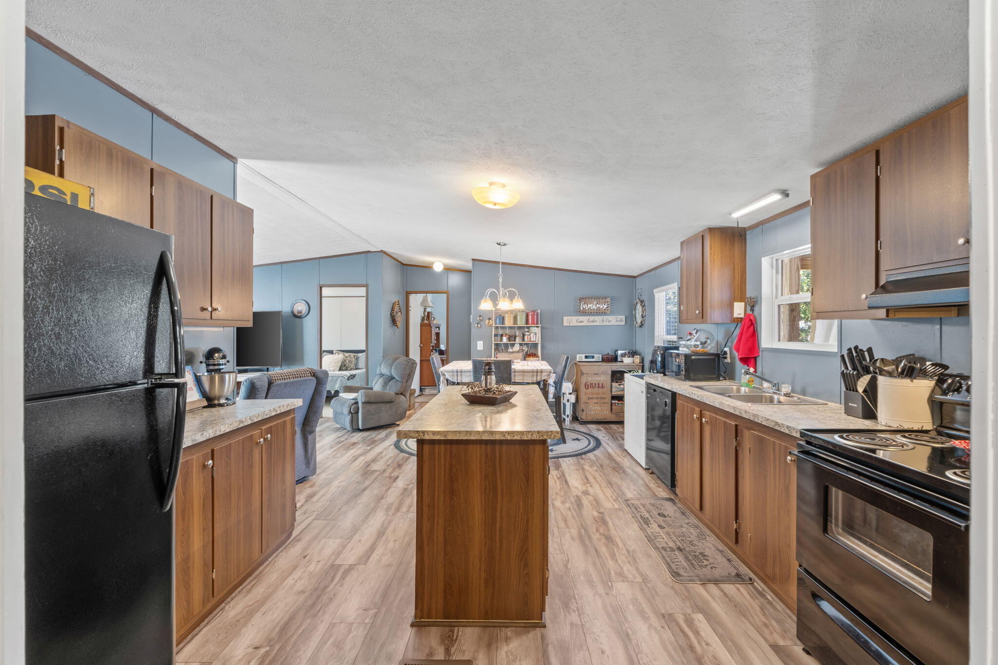 8680 John Hamm Road Milton, FL 32583 - Photo 13 of 44 a large kitchen with stainless steel appliances lots of counter space and wooden floor