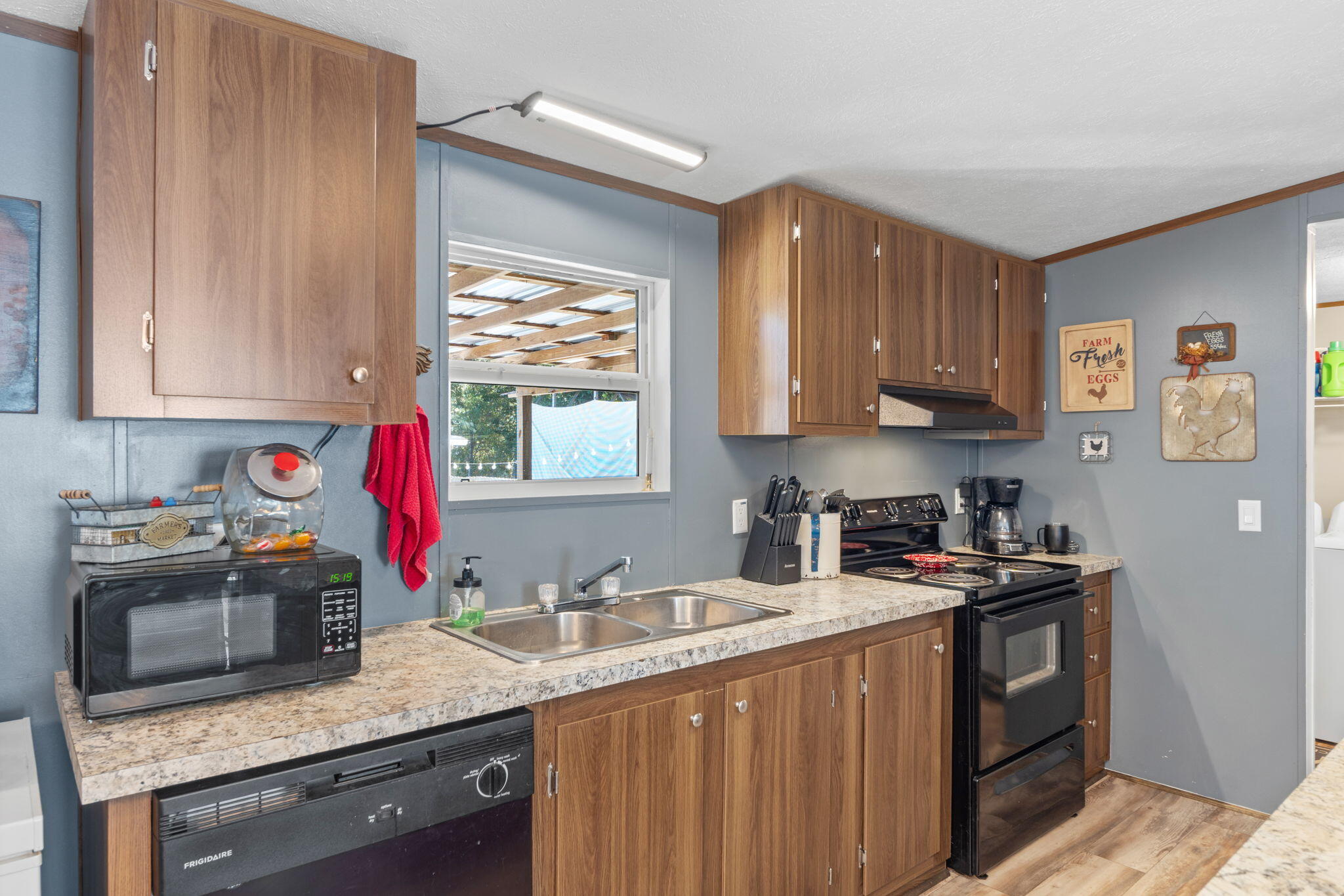8680 John Hamm Road Milton, FL 32583 - Photo 15 of 44 a kitchen with stainless steel appliances granite countertop a sink stove and refrigerator