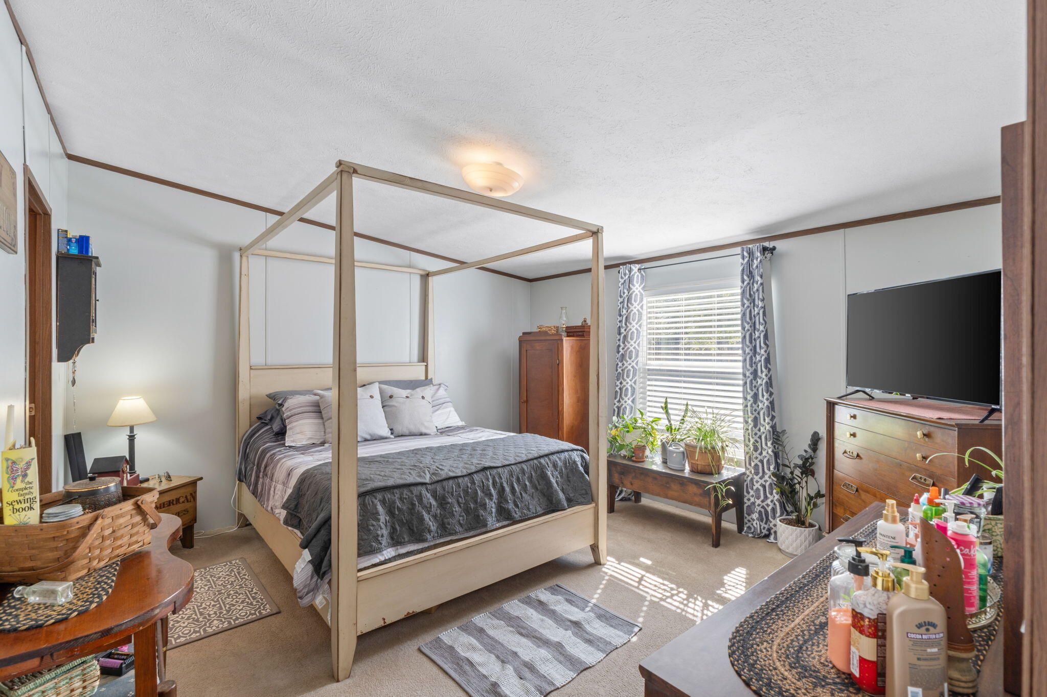 8680 John Hamm Road Milton, FL 32583 - Photo 18 of 44 a bedroom with a bed a flat screen tv and a couch