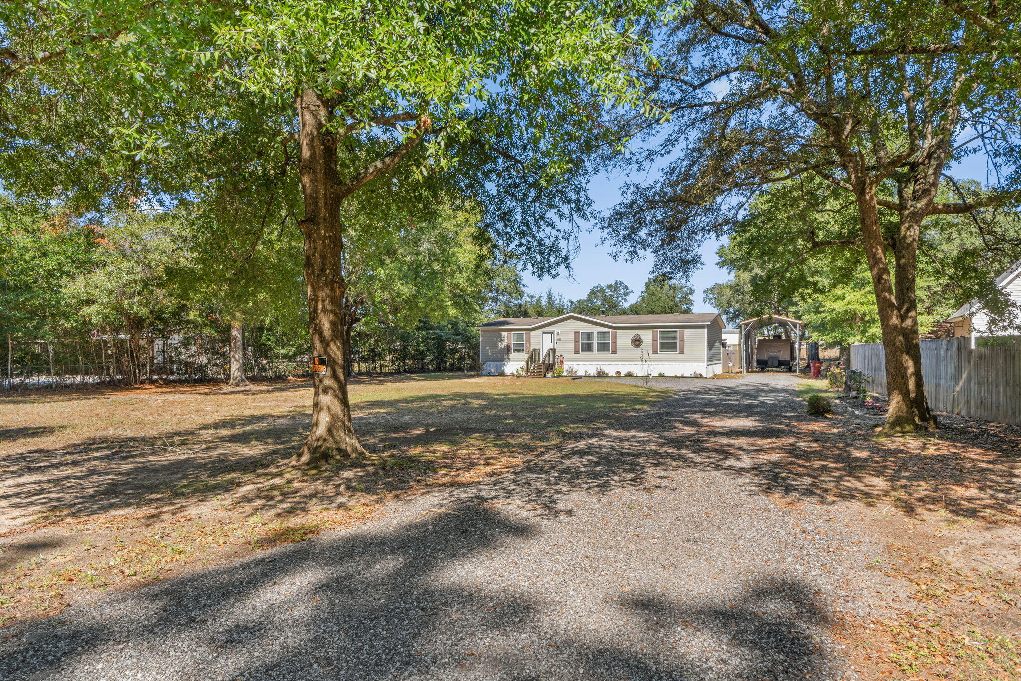 8680 John Hamm Road Milton, FL 32583 - Photo 2 of 44 a view of a tree in front of a house