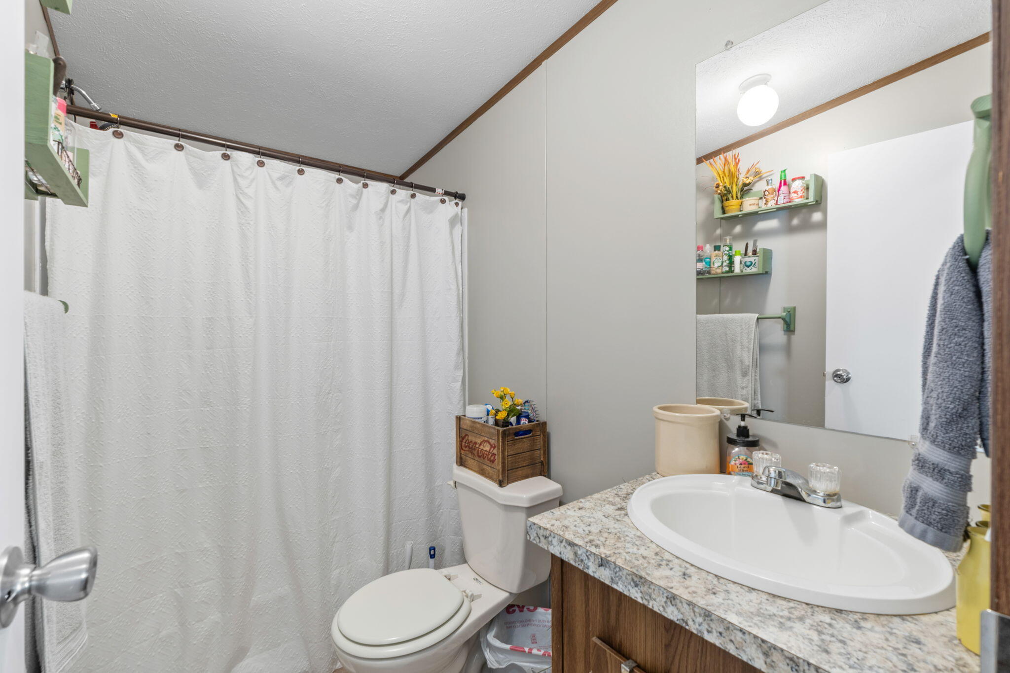8680 John Hamm Road Milton, FL 32583 - Photo 23 of 44 a bathroom with a granite countertop sink and a mirror with toilet