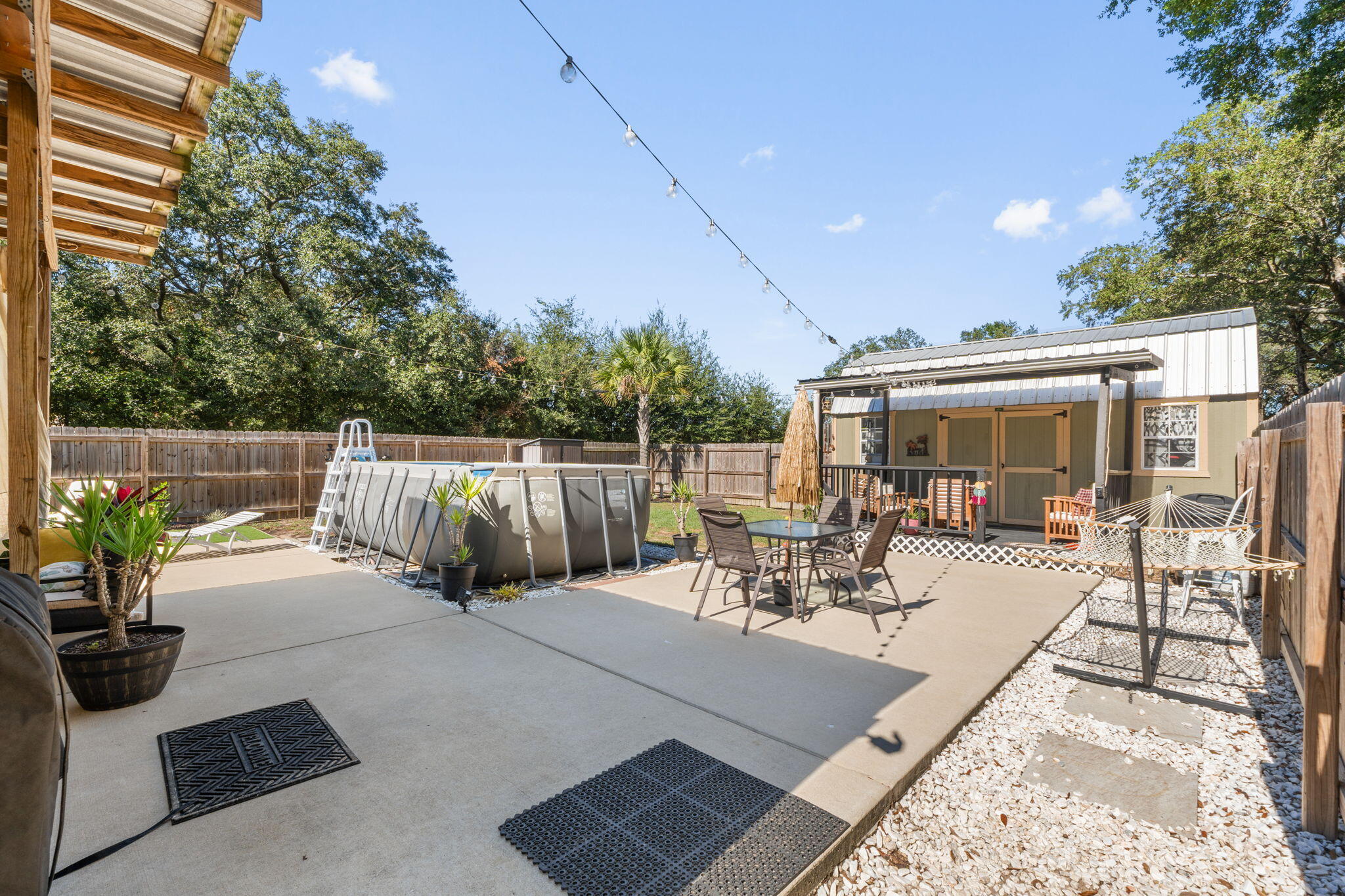 8680 John Hamm Road Milton, FL 32583 - Photo 26 of 44 a view of a patio with a dining table and chairs with a small yard