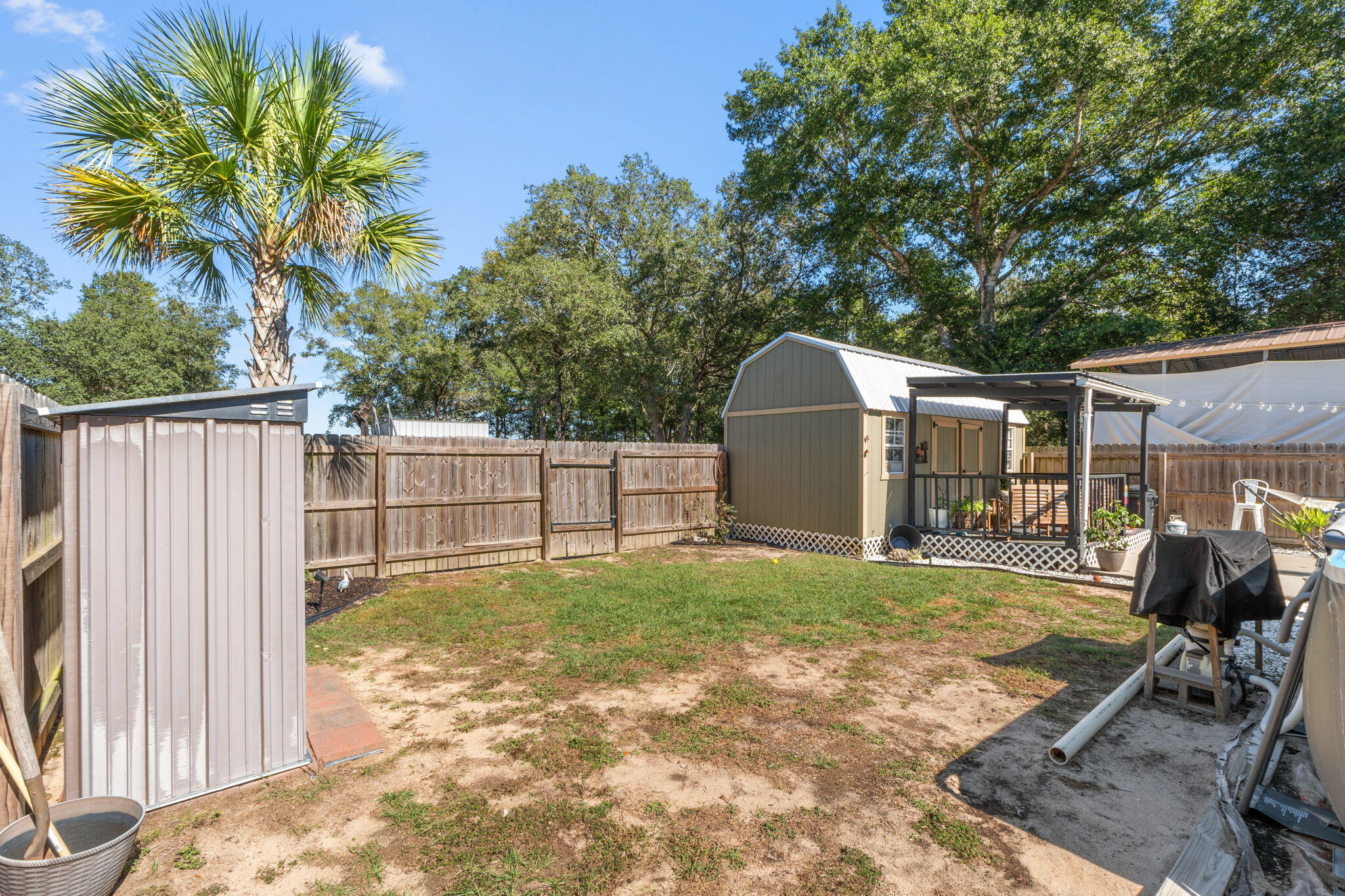 8680 John Hamm Road Milton, FL 32583 - Photo 30 of 44 a backyard of a house with table and chairs