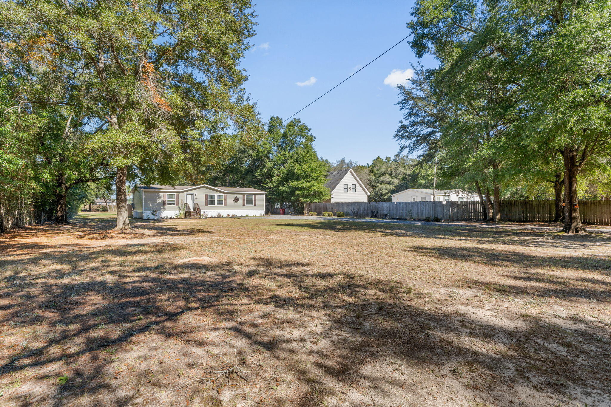 8680 John Hamm Road Milton, FL 32583 - Photo 3 of 44 a view of house with trees in the background