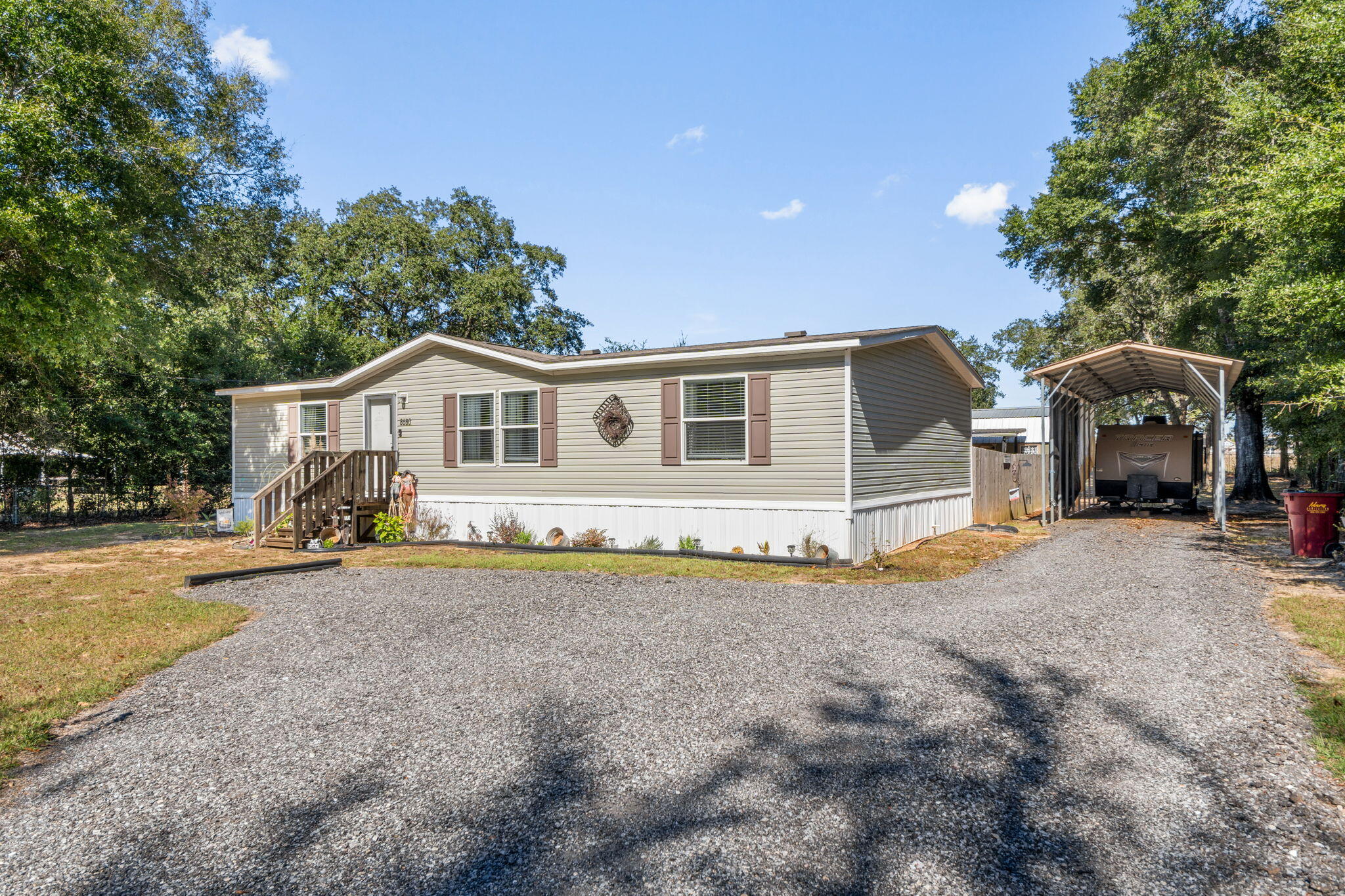 8680 John Hamm Road Milton, FL 32583 - Photo 4 of 44 a view of a house with backyard and a tree