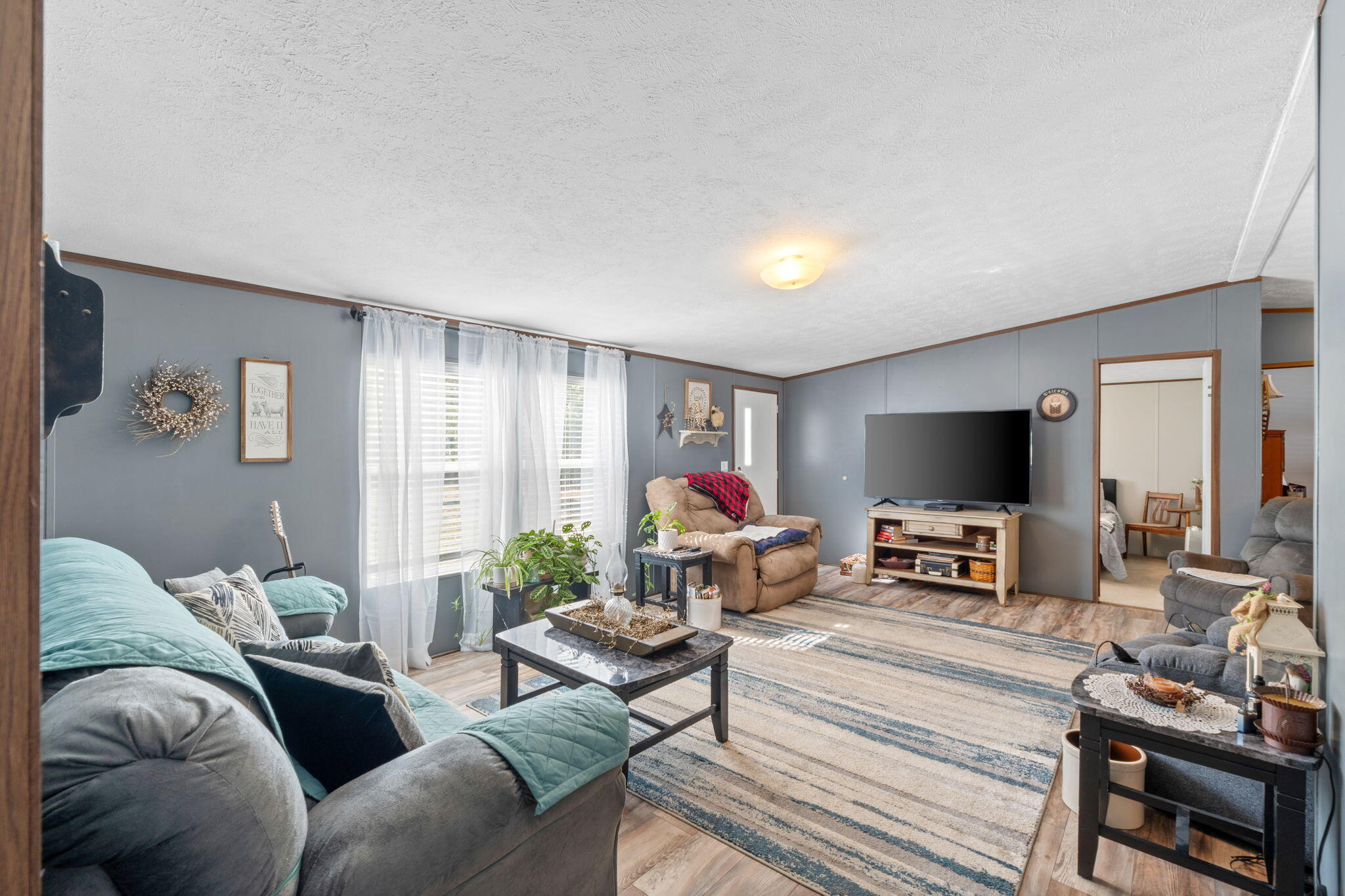 8680 John Hamm Road Milton, FL 32583 - Photo 8 of 44 a living room with furniture and a flat screen tv