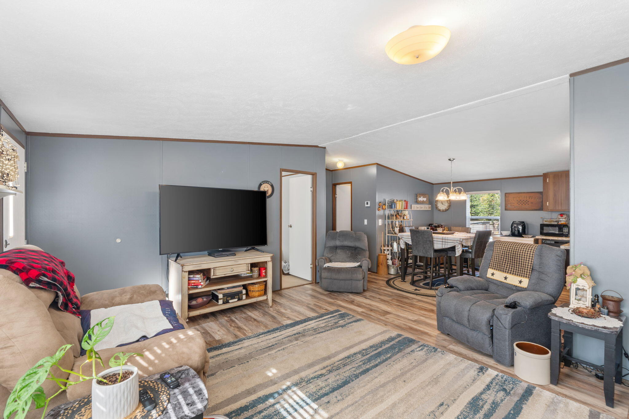 8680 John Hamm Road Milton, FL 32583 - Photo 9 of 44 a living room with furniture and a flat screen tv