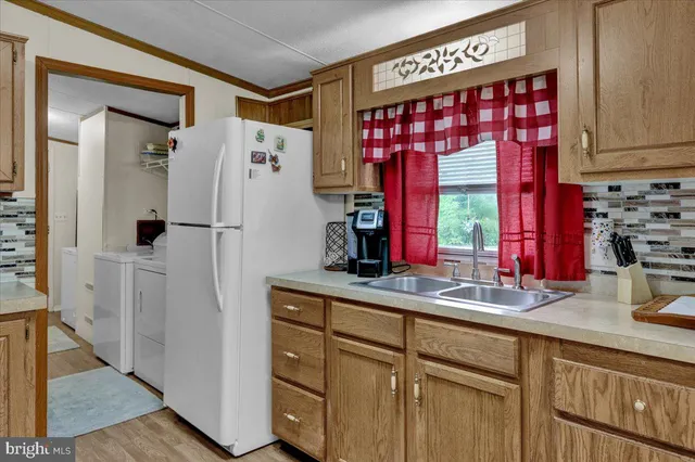 a kitchen with stainless steel appliances a refrigerator and a sink
