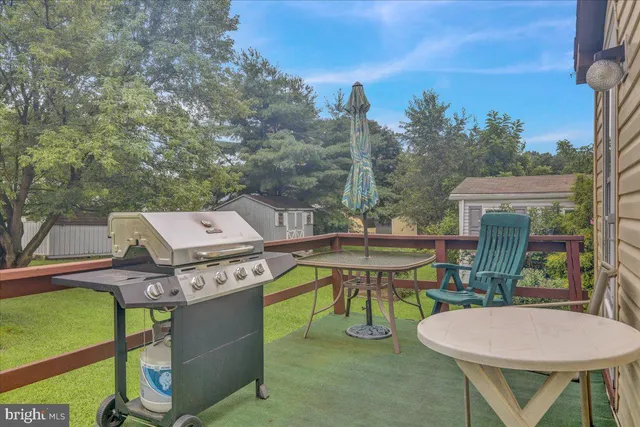 a balcony with table and chairs