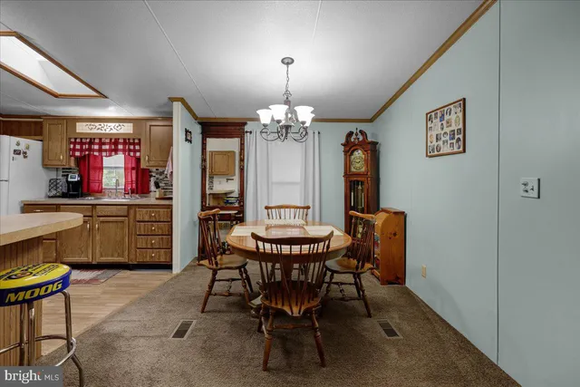 a view of a dining room with furniture and chandelier