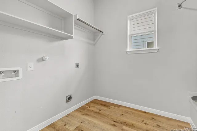 a view of a small space with wooden floor and a window