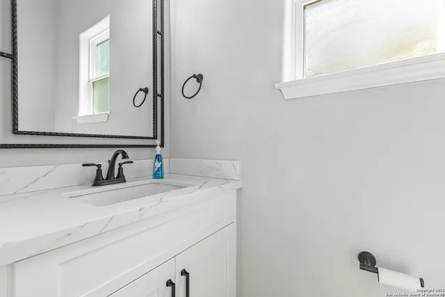 a bathroom with a sink and a mirror