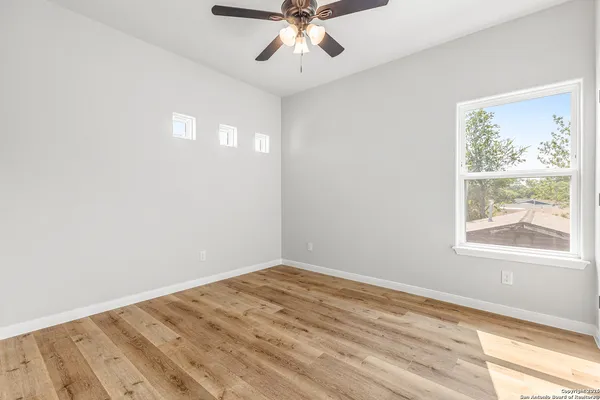 wooden floor in an empty room with a window