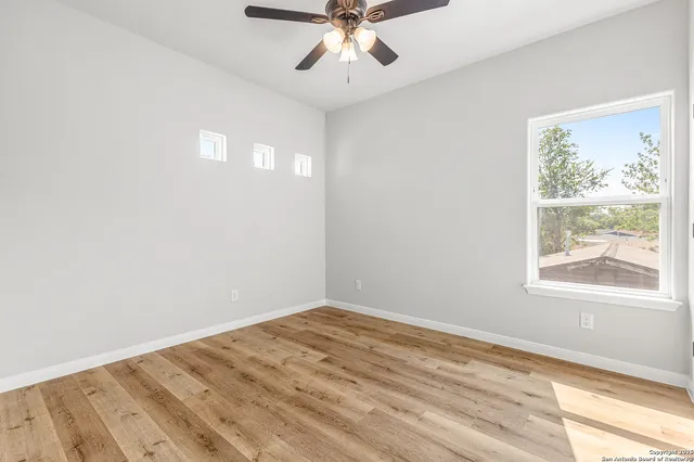 wooden floor in an empty room with a window