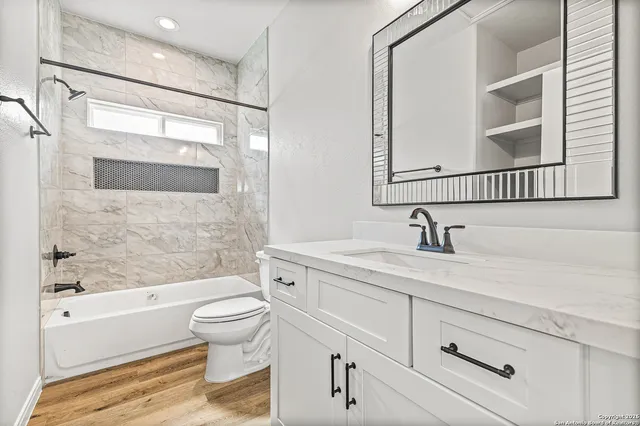 a bathroom with a sink a toilet and a bathtub