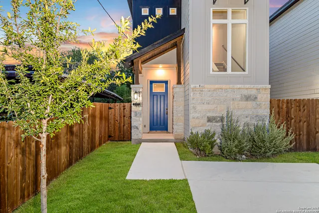 a view of a brick house with a yard